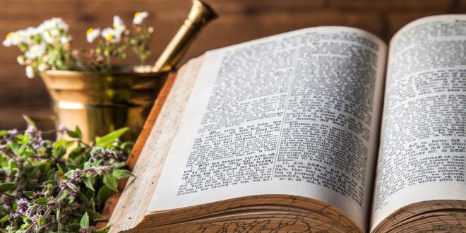 Ancient natural medicine, herbs and old herbal medicine book.